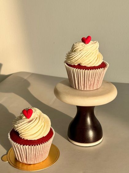My classic Red Velvet cupcakes are a customer favorite. The vibrant red cake is perfectly moist and topped with a tangy cream cheese frosting and a small red heart.