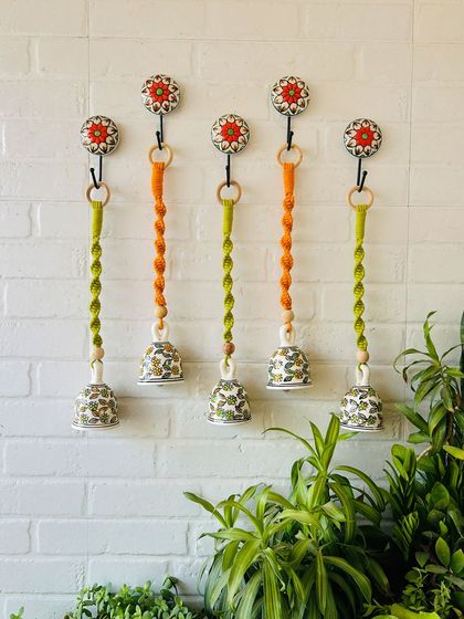 A beautiful set of five macrame ceramic bells in a combination of evergreen and orange. You can now customize your set with different colors to match your decor perfectly.