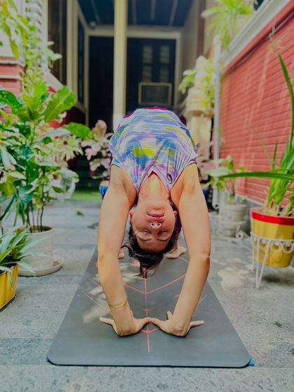 A wide-legged forward fold, Prasarita Padottanasana, allowing the head to hang heavy and release tension. This pose is a beautiful way to find your inner light and let it shine from within.