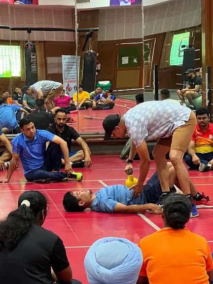 Demonstrating a technique for assessing an athlete's core function. Hands-on learning is a critical part of my coach education programs.