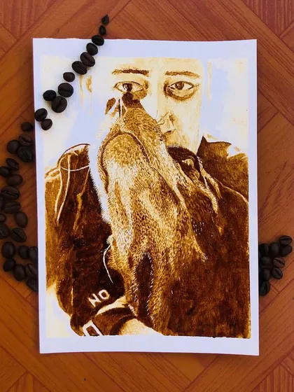 A portrait can be more than just paint on paper. This piece, created for a coffee lover, uses actual coffee to paint a tender moment with their beloved pet, making the artwork truly personal.