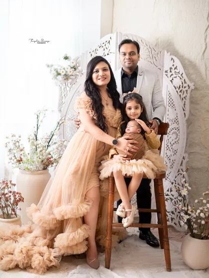 A newborn session is a celebration for the whole family. I captured this beautiful family of four, with the proud big sister holding her new baby sibling, creating a complete and heartwarming first family portrait.
