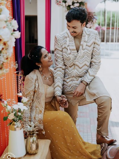 A sweet, candid moment between the couple during their colorful carnival-themed celebration.