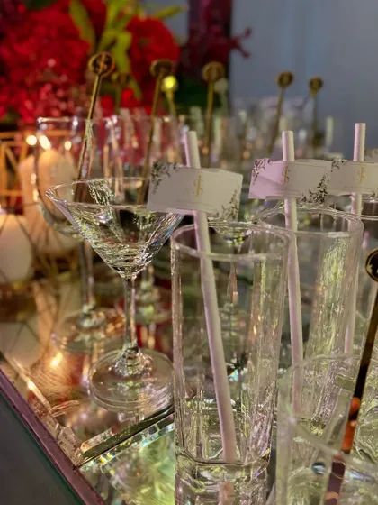 A variety of glassware, each prepared with personalized straws and stirrers, ready to be filled with our delicious cocktails.