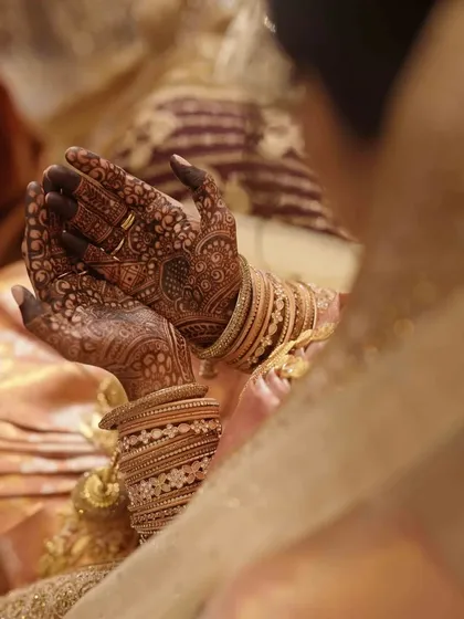 The final stain on a bride's hands, looking absolutely stunning with her wedding bangles. The deep color is a sign of a happy marriage ahead!