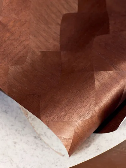 This rich, reddish-brown wood marquetry wallpaper showcases a subtle checkerboard pattern. The way the light catches the grain of the wood adds depth and a luxurious, tactile quality to the design.