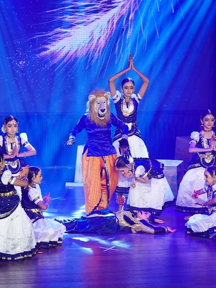A dramatic scene from "SREEMAN NARAYAN" depicting the story of Lord Narasimha. The use of masks and costumes brings the mythological tale to life.