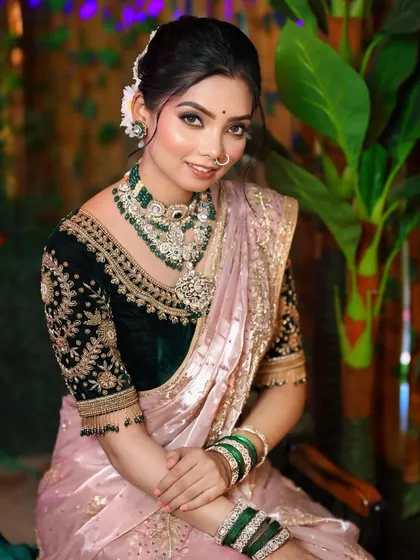 A closer look at the soft smokey eye and sculpted face. This makeup style adds a touch of glamour while complementing the traditional green bangles and nath.