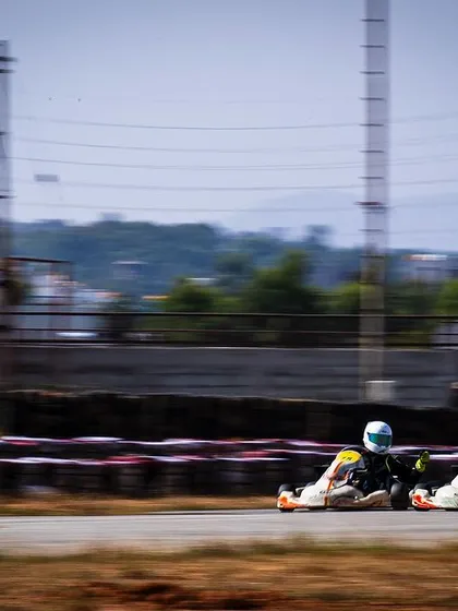 A long shot of two karts racing down the straight.