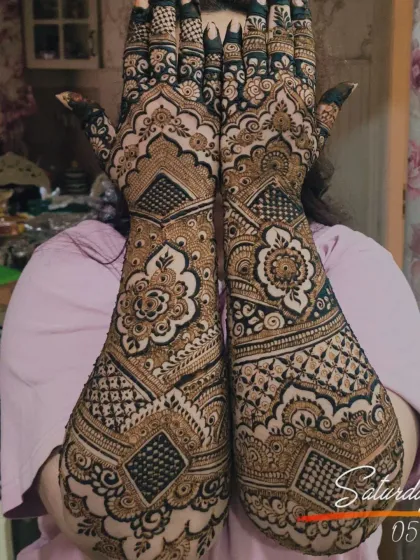 This is a classic, full-coverage bridal design I did for the mother of the bride. It features dense, traditional Indian patterns with geometric fills and floral elements, covering the hands and arms completely.