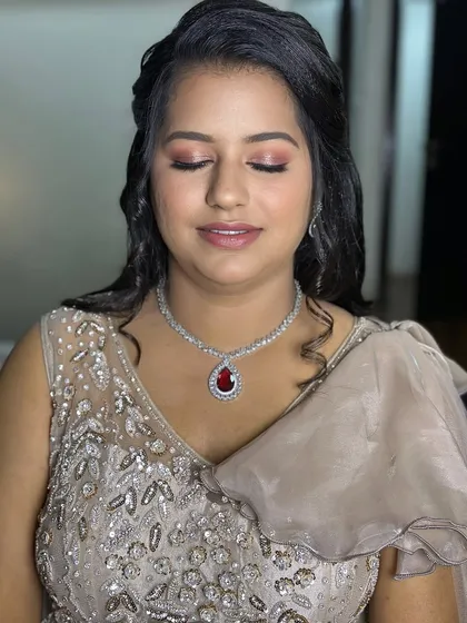 A lovely engagement look for Puja, with soft pink makeup that complements her beautiful smile.