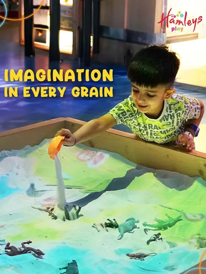 Imagination in every grain. A young boy creates a world of his own in our interactive sand play zone. Let their creativity run wild!