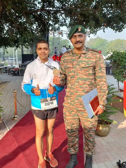 Giving a thumbs-up with my medal. A successful race day is a testament to months of disciplined training.