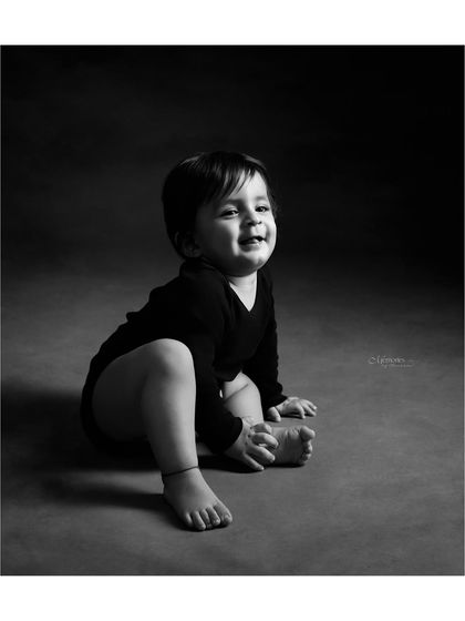 This happy one-year-old's smile is everything. A simple, classic black and white portrait is a timeless way to celebrate their big first birthday.
