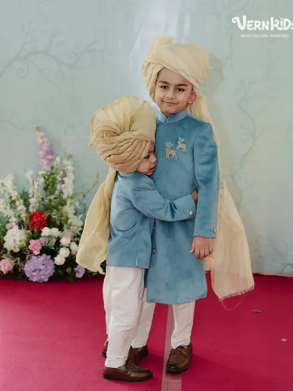There's nothing more special than sibling love, especially when they are dressed to match. These two brothers are picture-perfect in their coordinated blue velvet sherwanis and traditional turbans for a family wedding.
