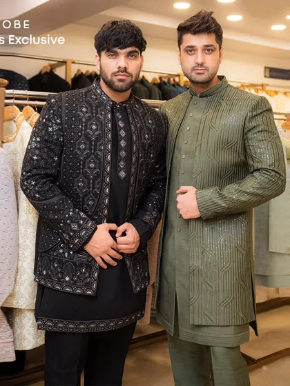 Two styles, one vibe. This image shows how you and a friend can coordinate in our collection, featuring a black embroidered jacket set and an olive green sherwani.