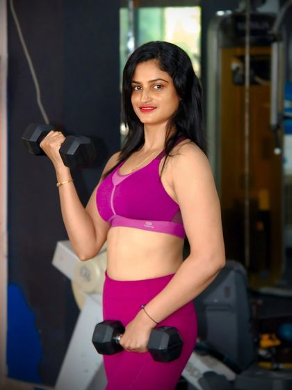 Strength training is for everyone. Here I am with a set of dumbbells, ready for a bicep curl session. Building toned arms is a common goal for many of my female clients.