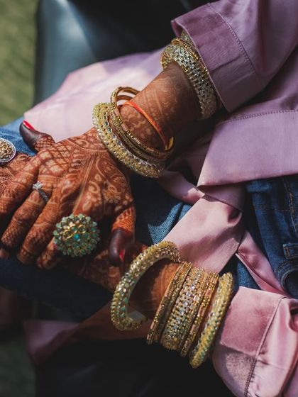 A modern bride's getting ready look: traditional henna and bangles paired with casual jeans. We love capturing this blend of old and new.