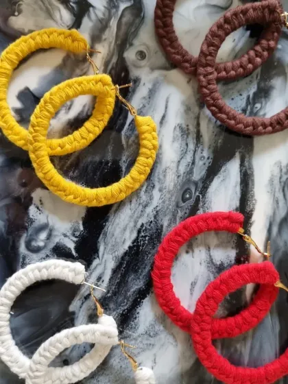 Explore the vibrant possibilities of macrame jewelry with these handcrafted hoop earrings. Available in a variety of colors like bold red, sunny yellow, classic white, and earthy brown, these lightweight earrings add a touch of bohemian style to any outfit.