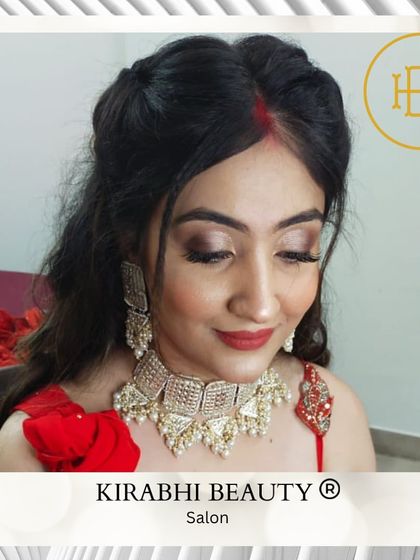 A beautiful client ready for a traditional event. Her makeup is classic and elegant, with a defined eye and red lip, paired with a traditional updo.