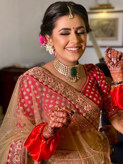 A candid moment of pure happiness. Her makeup is designed to look flawless even in motion, with a focus on glowing skin and eyes that dance.