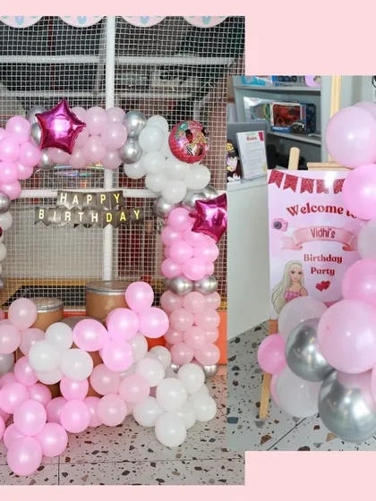 A pink and silver Barbie-themed balloon arch and welcome sign, perfect for a glamorous and fun birthday party.