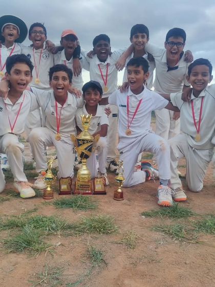 The victorious U-12 team posing with their championship trophy and medals. We believe in fostering a winning mentality and celebrating success as a team.