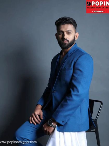 A seated pose in the blue suit, showing how comfortable and stylish it is. This is part of my exclusive collection, designed to offer unique options for my clients.