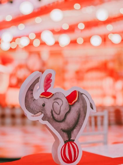 A tiny, whimsical detail from the circus carnival. This small elephant cutout adds another layer of thematic charm to the table decor, showing that no detail is too small.