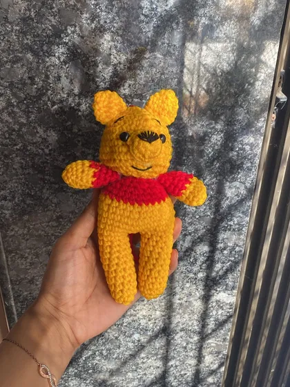 Holding the Pooh doll. It’s a great size to hold in your hand or sit on a shelf.