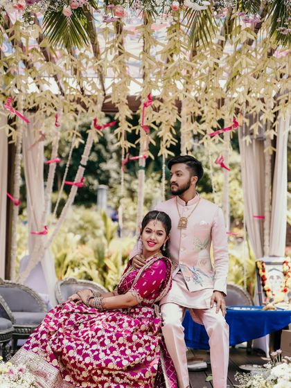 A lovely portrait of the couple at their outdoor engagement, framed by lush greenery.