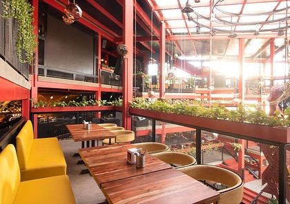 Inside Big Pitcher, planters are used along the railings of the multi-level space. This brings nature to every floor, ensuring that all guests have a view of greenery, which enhances the dining and social experience.