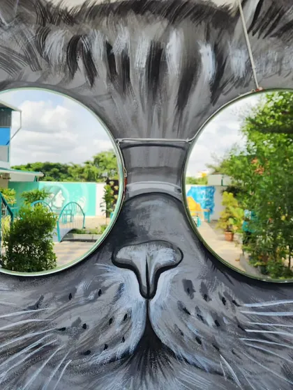 We love making art you can interact with. For this project, we painted a cool cat mural and integrated two circular mirrors as reflective sunglasses, creating a functional and playful piece for a commercial space.