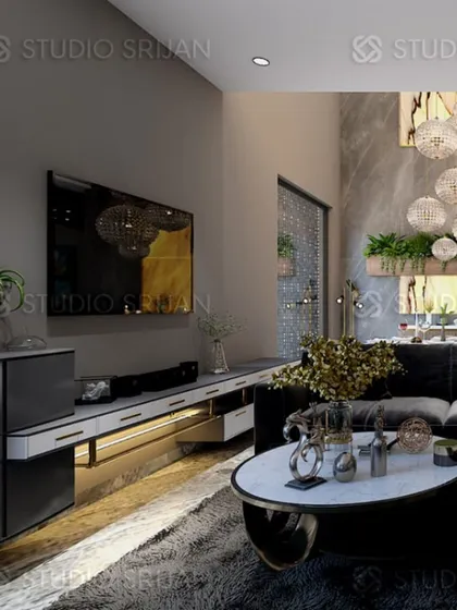 A lobby in Varanasi with a dark, moody theme, featuring a TV console with under-lighting and a dramatic, cascading chandelier.