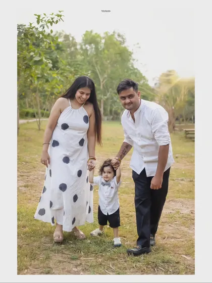 A family of three walks hand-in-hand through a park, creating a beautiful, dynamic portrait. We encourage movement and interaction to keep our outdoor sessions feeling natural and fun.