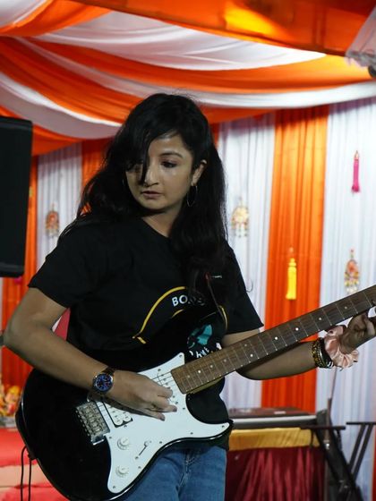 Another shot of our student Bhumi, focused and in her element on the electric guitar. She is a true performer.