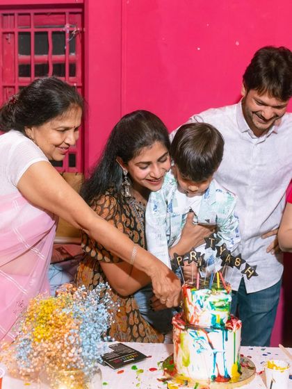 A heartwarming moment as the birthday boy and his family cut into the colorful cake that all the kids helped decorate.