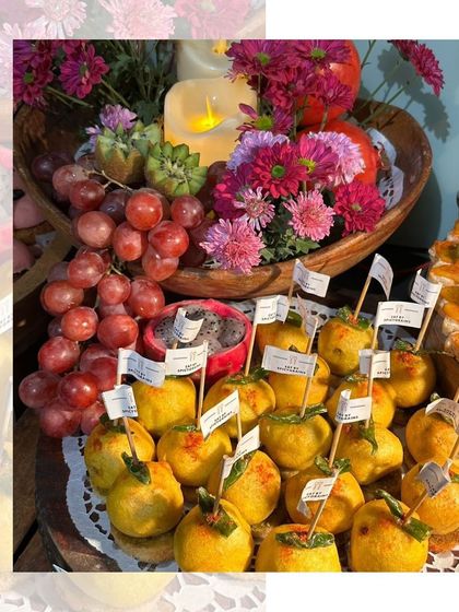 A festive display of mini Vada Pavs, adorned with fresh flowers and grapes. We love getting creative with our presentation.