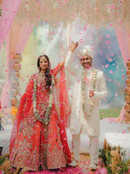 A shower of love and petals. This beautiful shot captures the couple's joy right after their varmala exchange.
