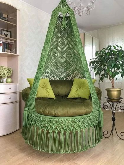 An exclusive macrame swing in a rich olive green. This piece combines comfort with luxury, perfect for relieving tiredness after a long day.