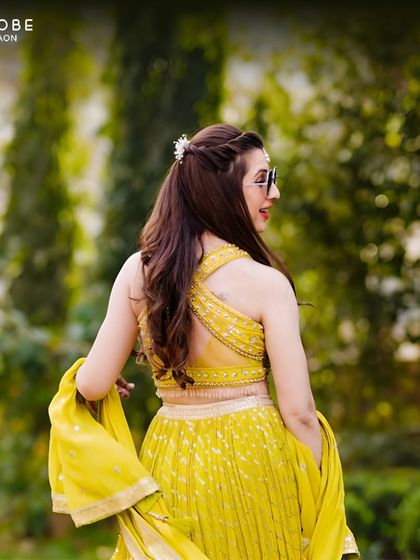 The stylish cross-back design of this yellow Haldi lehenga adds a modern twist to a traditional look. It's comfortable, chic, and photo-ready.