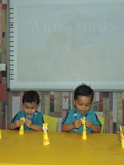 Little hands are busy creating giraffe crafts. We use art to reinforce lessons about the animal kingdom, making learning a creative and hands-on process.