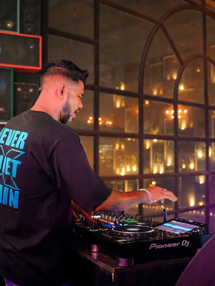 In the mix at Bombay Adda Bangalore. The warm, ambient lighting of the club creates an intimate yet energetic setting.