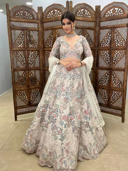 This off-white lehenga with multi-color floral embroidery is a fresh and vibrant choice.