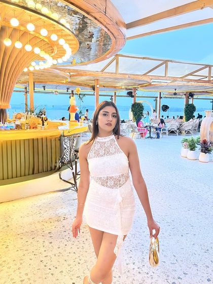 A confident walking pose inside the stunning beach club.