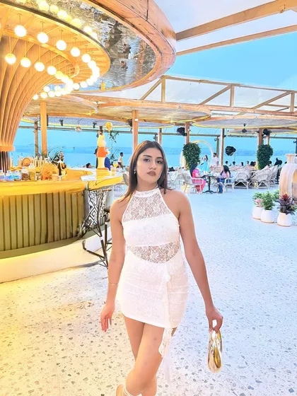 A confident walking pose inside the stunning beach club.