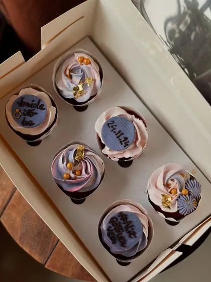 A beautiful set of cupcakes for a bridal shower. I used a mix of delicate frosting swirls, edible gold leaf, and custom fondant plaques with the wedding date to create an elegant look.