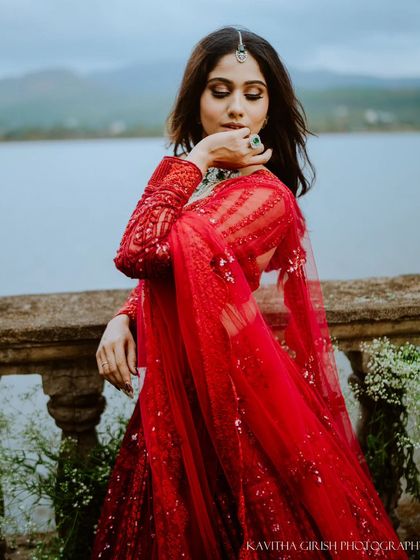 A stunning solo portrait of the bride-to-be in her elegant red gown. Pre-wedding sessions are a wonderful opportunity to capture individual portraits as well.