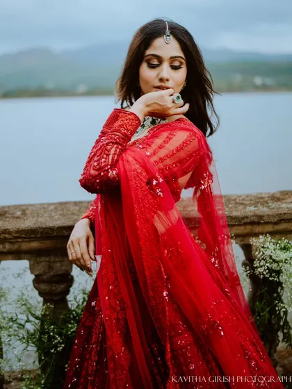 A stunning solo portrait of the bride-to-be in her elegant red gown. Pre-wedding sessions are a wonderful opportunity to capture individual portraits as well.