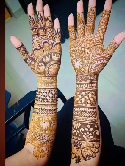 A clear, bright shot of the intricate elephant and peacock mehandi, showing the fine details in the artwork.